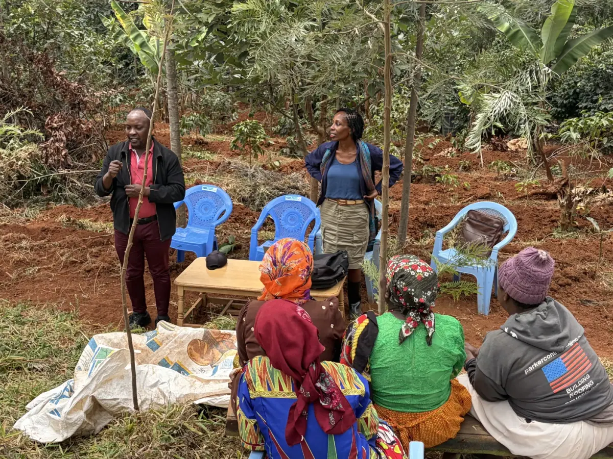 Vivian Nwakah and a field trainer speaking with farmers in Murang'a, Kenya